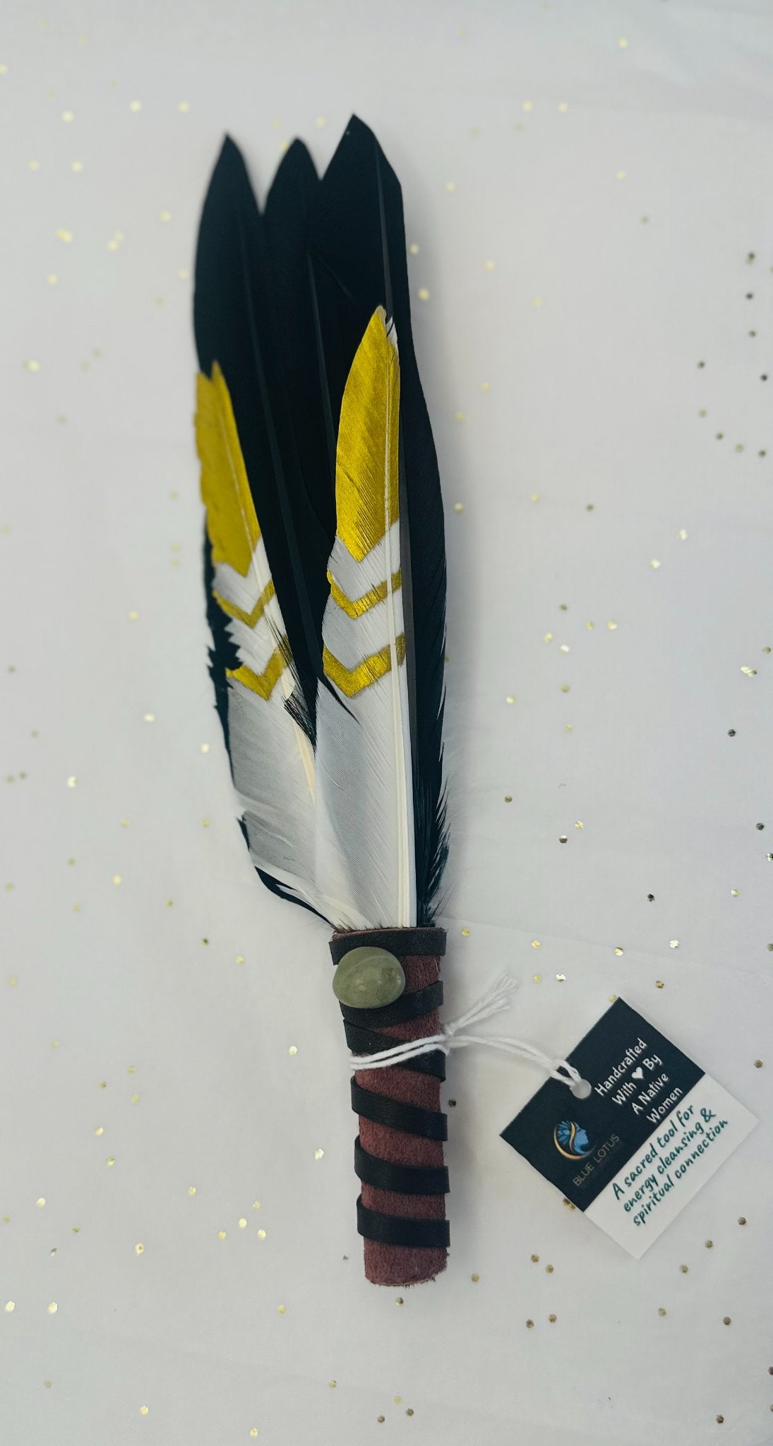 683f8647fae72e57618b2b3e_black-and-gold-smudging-feather_1751526720737.jpg